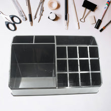 Cosmetic organizer box with clear compartments, showcasing its use for organizing makeup