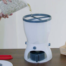 Dispenser with grains being poured out.